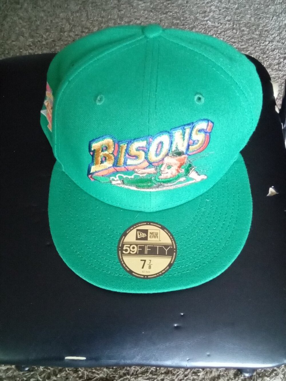 The product is a designer New Era baseball cap in a unique green color, featurin